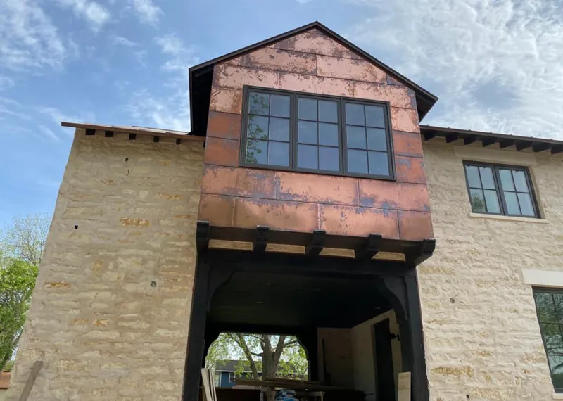 Copper metal panel facade on a stone building for Metal Roof Coating in Fair Lakes